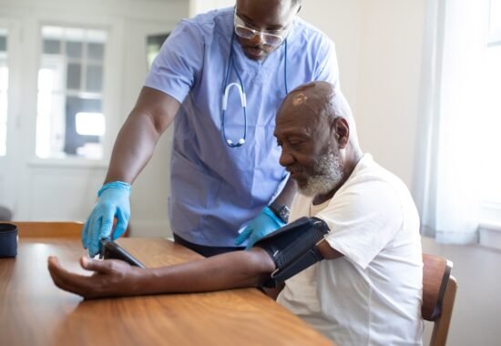 Doctor taking man's blood pressure